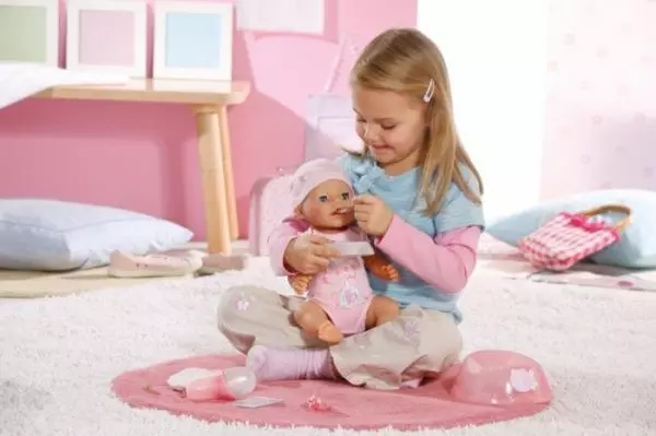 Девочка играет с куклой